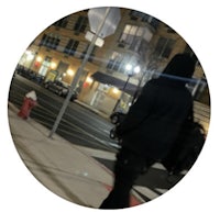 a person walking down the street at night